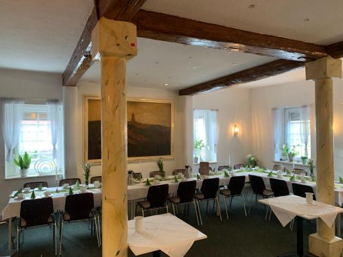 a large room with tables and chairs in it at Landgasthof Zum Ring in Ringleben