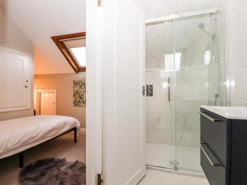 a bathroom with a shower and a sink at Carpenters in Sandwich