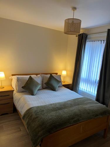 a bedroom with a bed with two pillows and a window at The Nest in Belfast