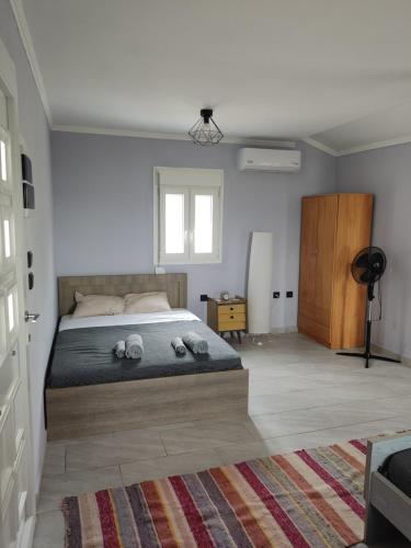 a bedroom with a bed with slippers on it at Ouranoupolis View Point in Ouranoupoli