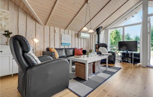 a living room with a couch and a table at Three-Bedroom Holiday Home In Dannemare in Dannemare