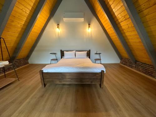 a bedroom with a bed in a attic at ROSE SAPANCA STONE HOUSE in Sakarya