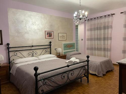 sypialnia z 2 łóżkami i żyrandolem w obiekcie CA' DIJ SARACH w mieście Canelli