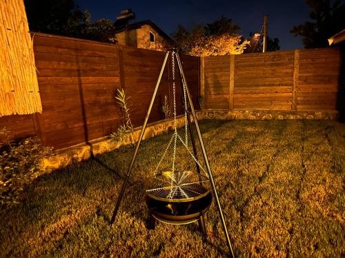 a wheelbarrow in a yard with a fence at ROSE SAPANCA STONE HOUSE in Sakarya