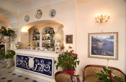 a bar in a room with two chairs and a mirror at Hotel Santa Lucia in Minori