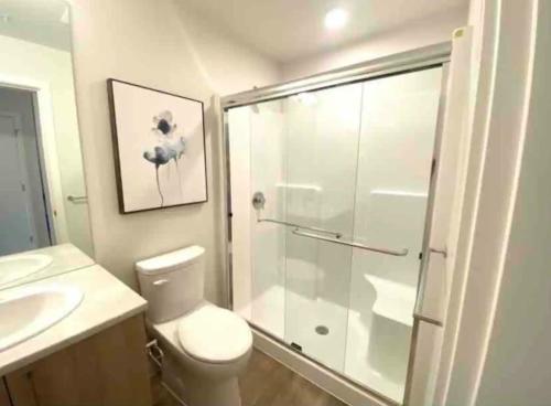 a bathroom with a shower and a toilet and a sink at Perfect Brand New Studio Downtown Sidney in Sidney
