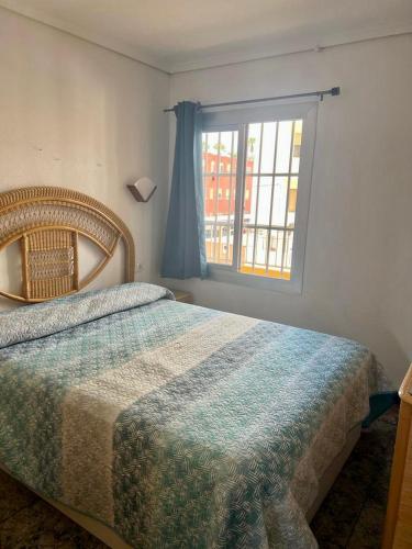 a bedroom with a bed and a window at Casa Schila in Tavernes de Valldigna