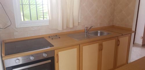 a small kitchen with a sink and a stove at Casita Beach Front in Torrox Costa