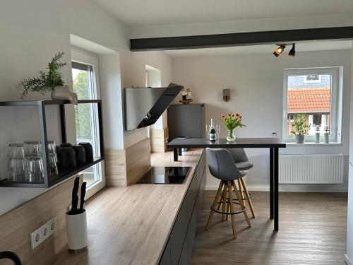 a kitchen with a counter and a table in a room at Kühlhaus Hagenburg in Hagenburg