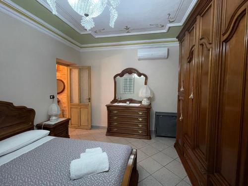 a bedroom with a bed and a dresser and a mirror at CA' DIJ SARACH in Canelli