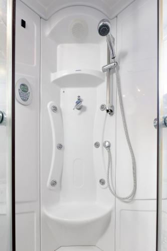 a shower in a bathroom with a glass door at Moro Vrbnik in Vrbnik