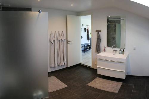 a bathroom with a sink and a mirror at Bright summer house close to the beach and water in Holbæk