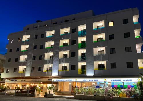 a rendering of the exterior of a hotel at night at Aparthotel Boutique Poniente Playa in San Antonio