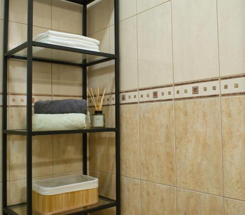 uma prateleira na casa de banho com uma parede em azulejo em NIVI Apartment em Split