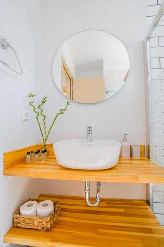 a bathroom with a sink and a mirror at Elianthos Luxury Villas in Tsoukalades