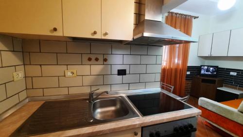 a kitchen with a sink and a counter top at Lovely appartament B in Tirana