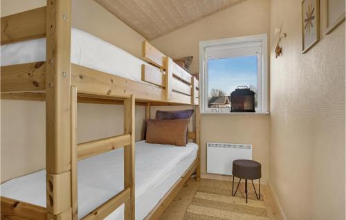 ホーフブルグにあるGorgeous Home In Hovborg With Kitchenの二段ベッド2組、窓が備わる客室です。