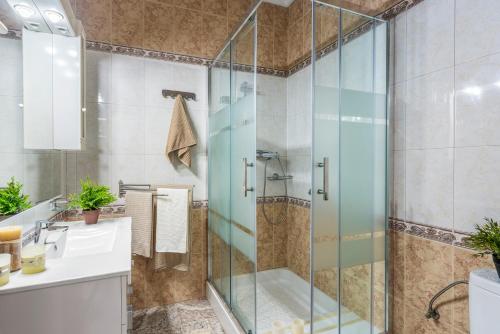 W łazience znajduje się szklana kabina prysznicowa i umywalka. w obiekcie Beautiful house with sea views and private pool w mieście Torrevieja