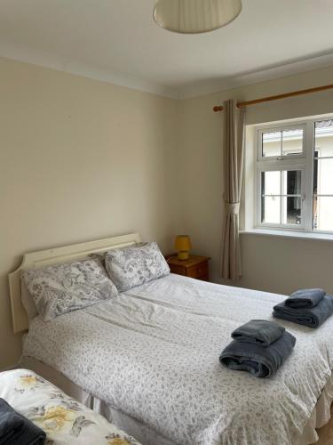 a bedroom with a bed with two towels on it at Hillside House- Pine View in Ballinamuck
