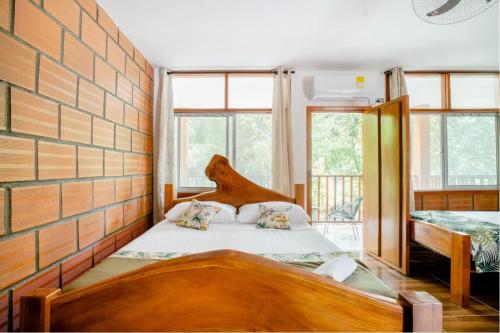 a bedroom with a bed in a brick wall at Arca Tayrona Restaurant & Hostal in Santa Marta