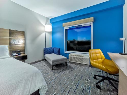 a hotel room with a bed and a large window at Holiday Inn Express - Huntsville Space Center by IHG in Huntsville