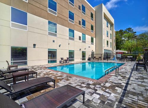 a swimming pool in front of a building at Holiday Inn Express - Huntsville Space Center, an IHG Hotel in Huntsville