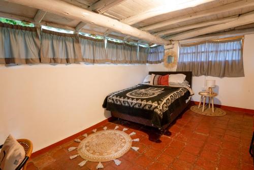 1 dormitorio con 1 cama en una habitación en Cabaña Kinti Q'umir Umiña en Kinti Wasi, en Los Baños del Inca