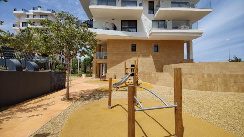 a playground in front of a building at ALLONBAY sun & beach penthouse in Villajoyosa