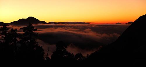 a sunset in the mountains with a layer of clouds at Tetxe B&B Roncal in Roncal
