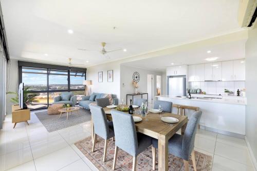 a kitchen and living room with a table and chairs at 'Opal of Darwin' Breezy Living Atop Blue Horizons in Darwin