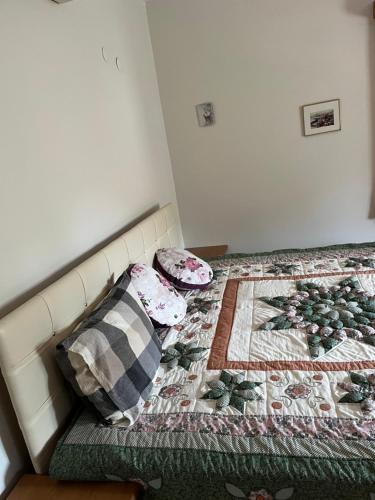 a bed with pillows and a quilt on it at A nice villa Near the city and the AirPort and the beach in Dalaman