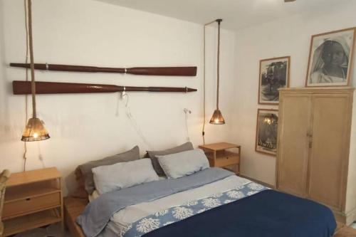 a bedroom with a bed and a chandelier at Centro Lampedusa via Roma in Lampedusa