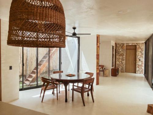 a dining room with a table and chairs and a large window at BOA BOA Bacalar in Bacalar