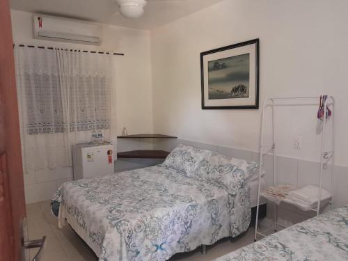 a hospital room with two beds and a window at Recanto Suítes in Araruama