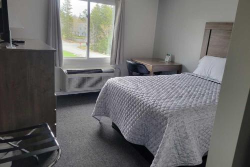 a hotel room with a bed and a window at Kimball Terrace Inn in Northeast Harbor