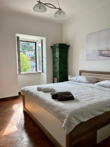 a bedroom with a large bed with two towels on it at Apartment by the sea in Ika
