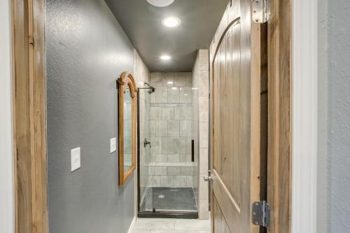 a bathroom with a walk in shower next to a door at Riverfront Two Rivers Vacation Rental By Beaches in Two Rivers