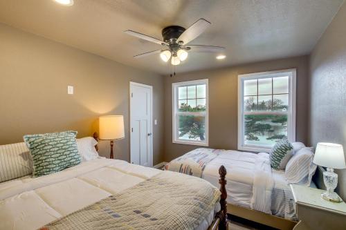 a bedroom with two beds and a ceiling fan at Riverfront Two Rivers Vacation Rental By Beaches in Two Rivers