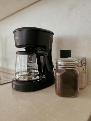 a blender sitting on a counter next to a jar at BOA BOA Bacalar in Bacalar