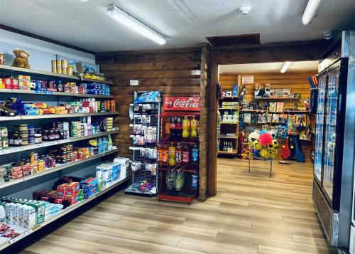 a store aisle of a grocery store filled with products at Mortonhall in Edinburgh