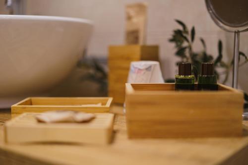 a table with three wooden boxes on top of it at Milestones Modern Suite Trullo Jacuzzi Spa & Relax in Alberobello
