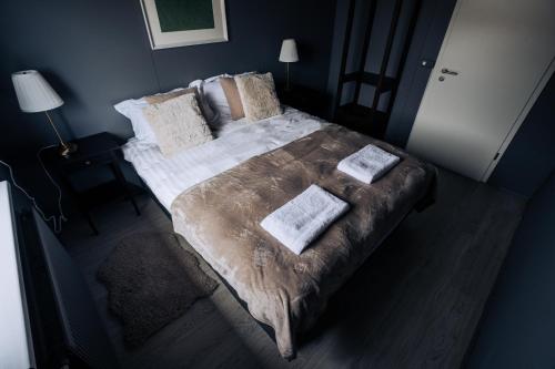 a bedroom with a large bed with blankets and pillows at Golden Circle Luxury Cottages Lake View in Selfoss