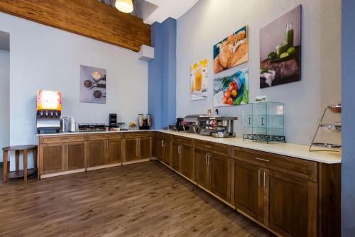 a kitchen with wooden cabinets and a counter top at Best Western Bordentown Inn in Bordentown