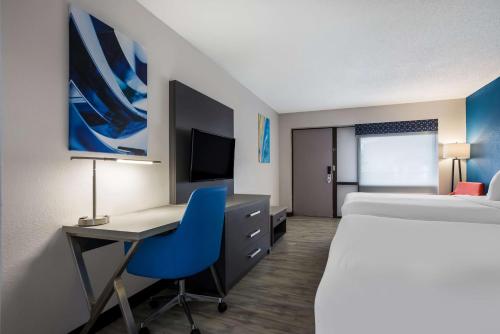 a hotel room with a bed and a desk with a computer at Best Western Bordentown Inn in Bordentown