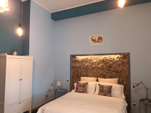 a bedroom with a large bed with white sheets and pillows at Al Palazzetto di Milo in Milo