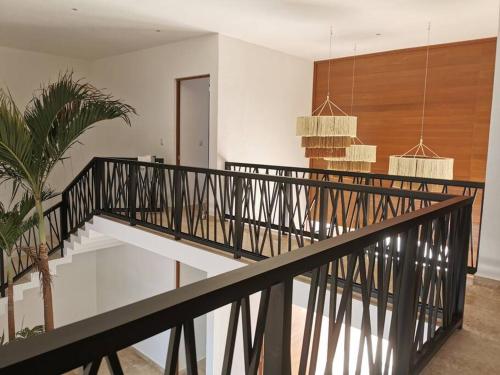 a staircase in a house with a plant at Villa de lujo frente al mar de Progreso in Progreso