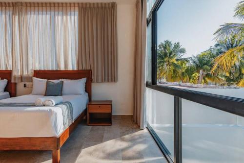 a bedroom with a bed and a large window at Villa de lujo frente al mar de Progreso in Progreso