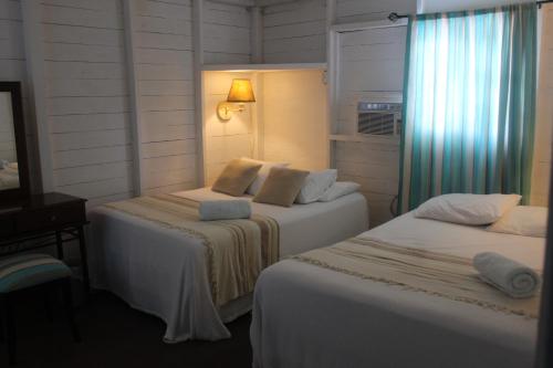 Postel nebo postele na pokoji v ubytování Hostal Corotu