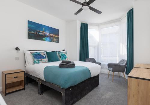 a bedroom with a large bed with green curtains at Charles Alexander Short Stay - TheWestern Blackpool in Blackpool