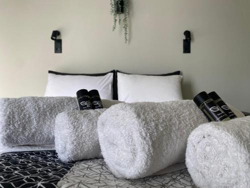 a bedroom with two gray couches with pillows at Mellow Paros in Parikia